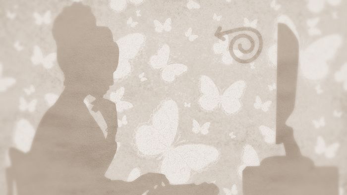 Silouhette of a woman on a yellow background looking at a screen in concentration, her hand under her chin.